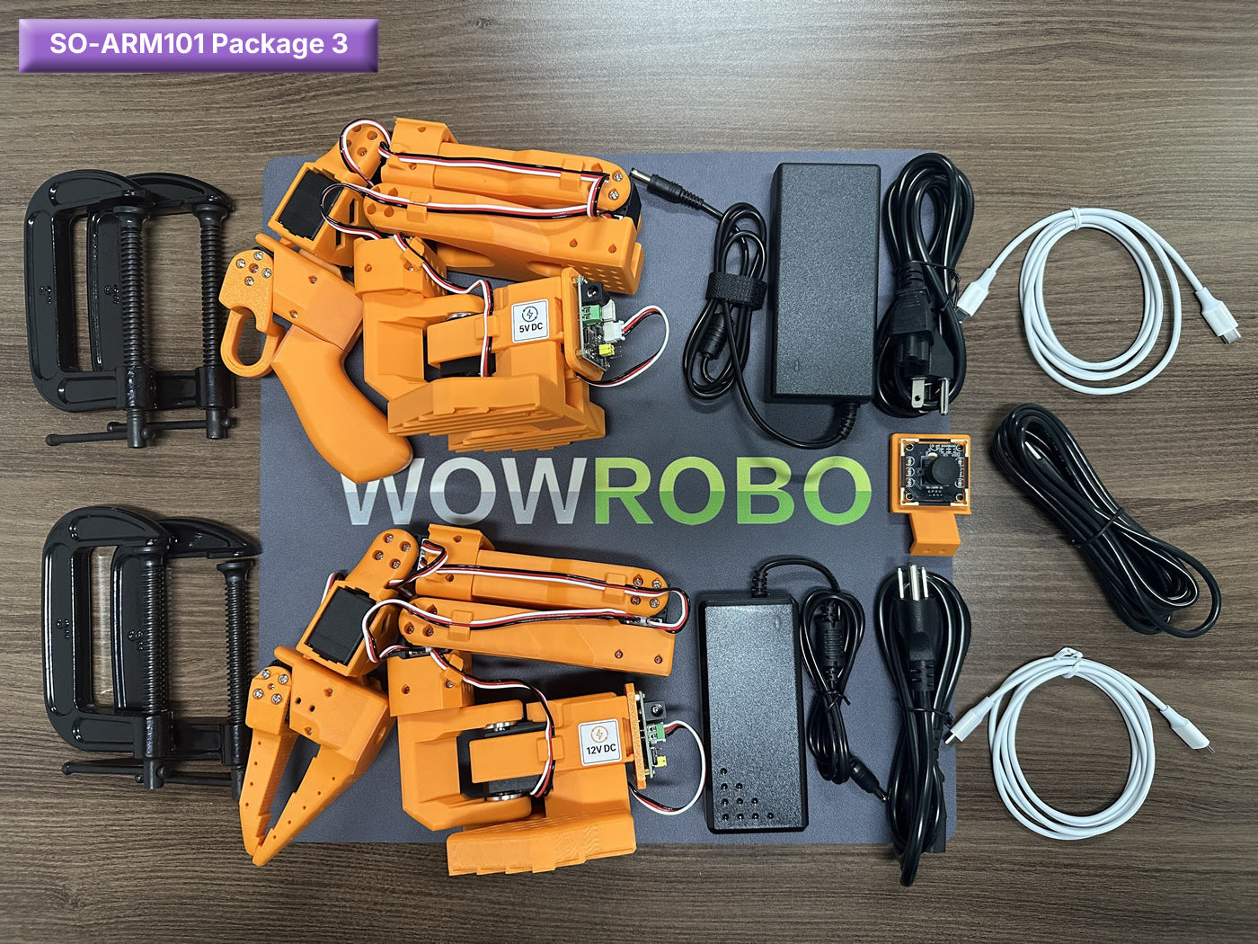 SO-ARM101 Package 3 includes robotic arms, servos, power supplies, cables, and clamps for DIY assembly.