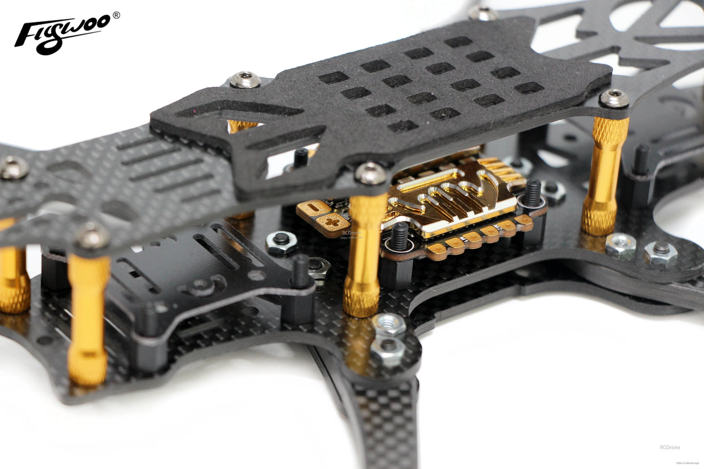 Insulation board plate installed on a quadcopter frame between the FC/ESC stack and carbon fiber plates