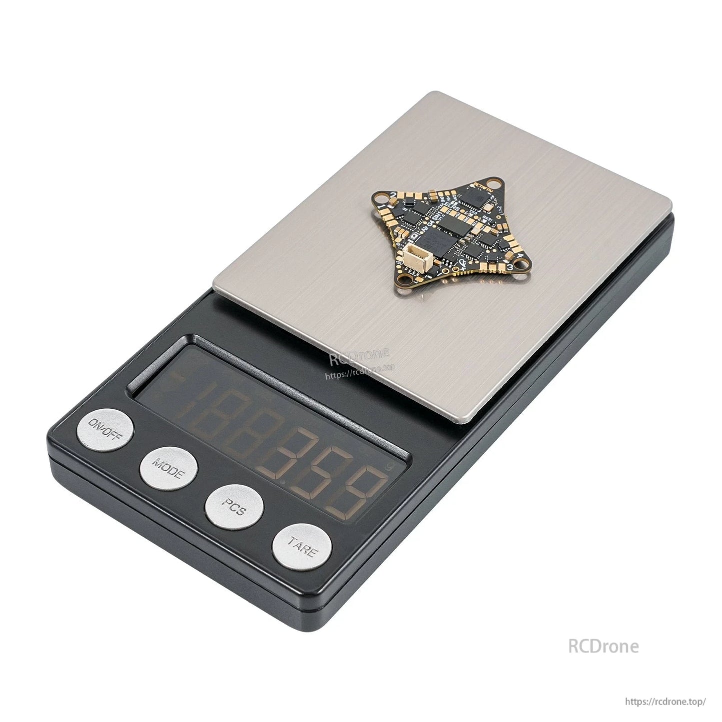 Brushless flight controller board on digital scale from alternate angle, showing compact triangular shape