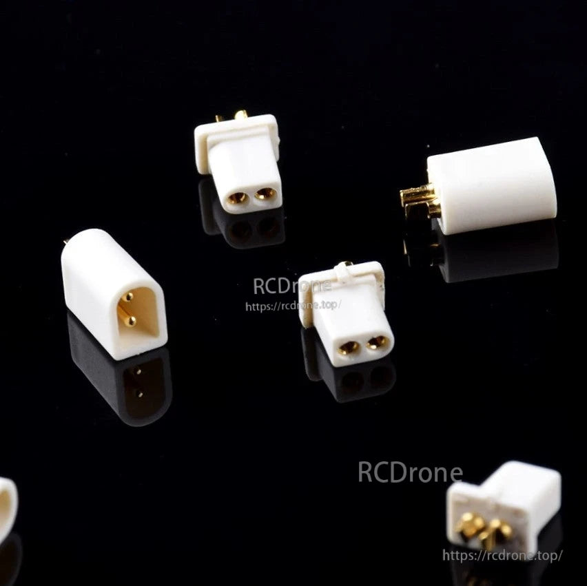 White 2‑pin micro battery connectors with gold pins arranged on black surface, RCDRone watermark visible