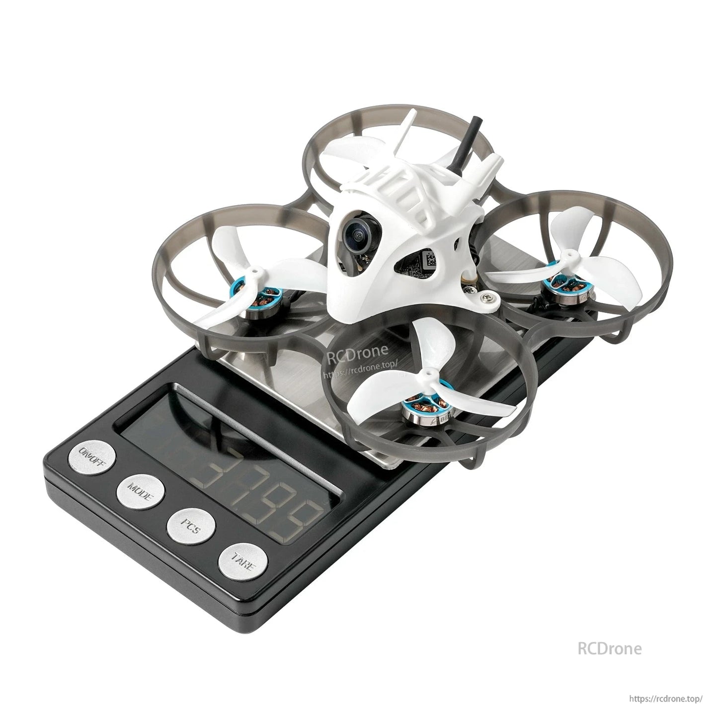 BETAFPV ducted micro FPV quadcopter with white canopy and front camera sitting on a digital scale