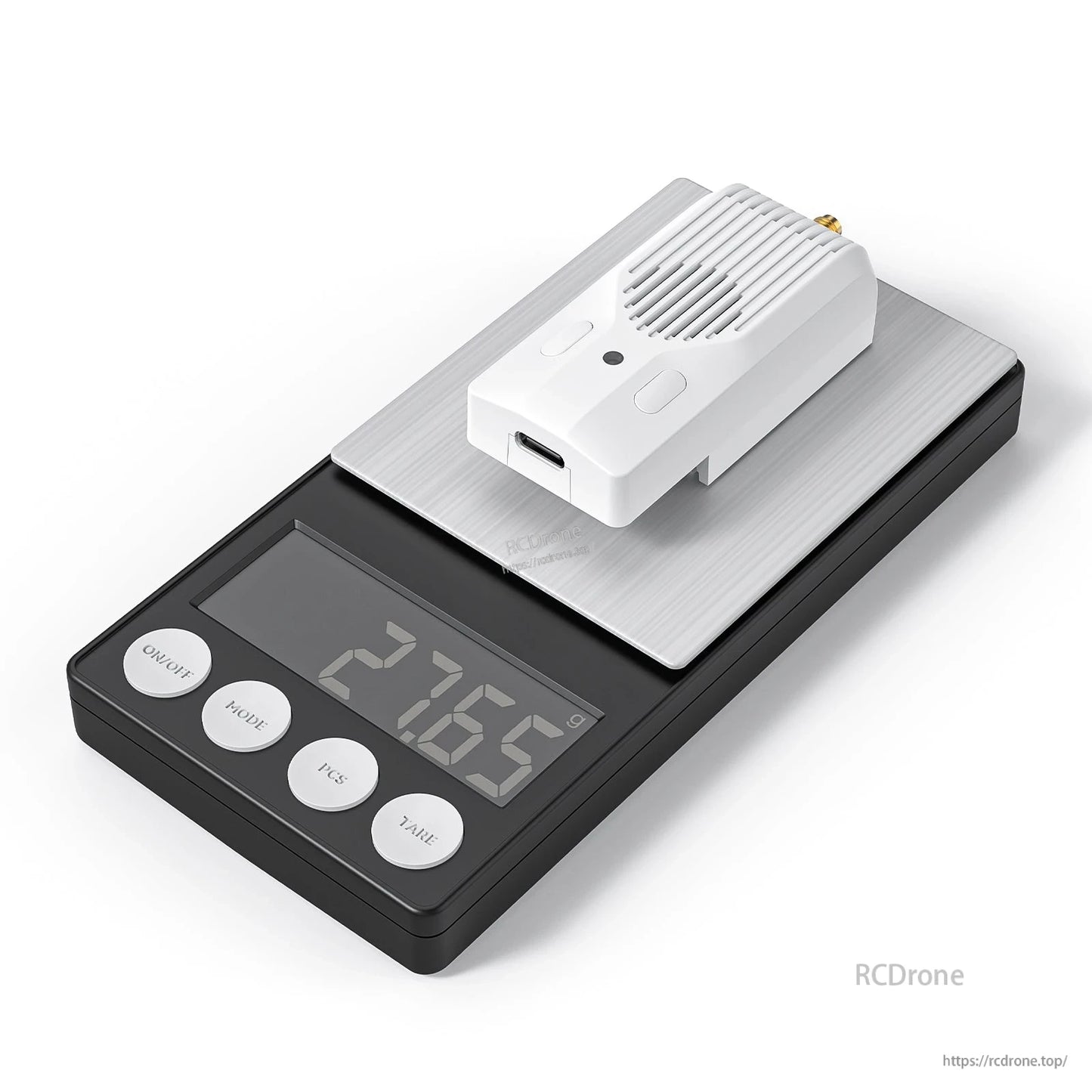 Module resting on a digital scale, showing weight readout on the display