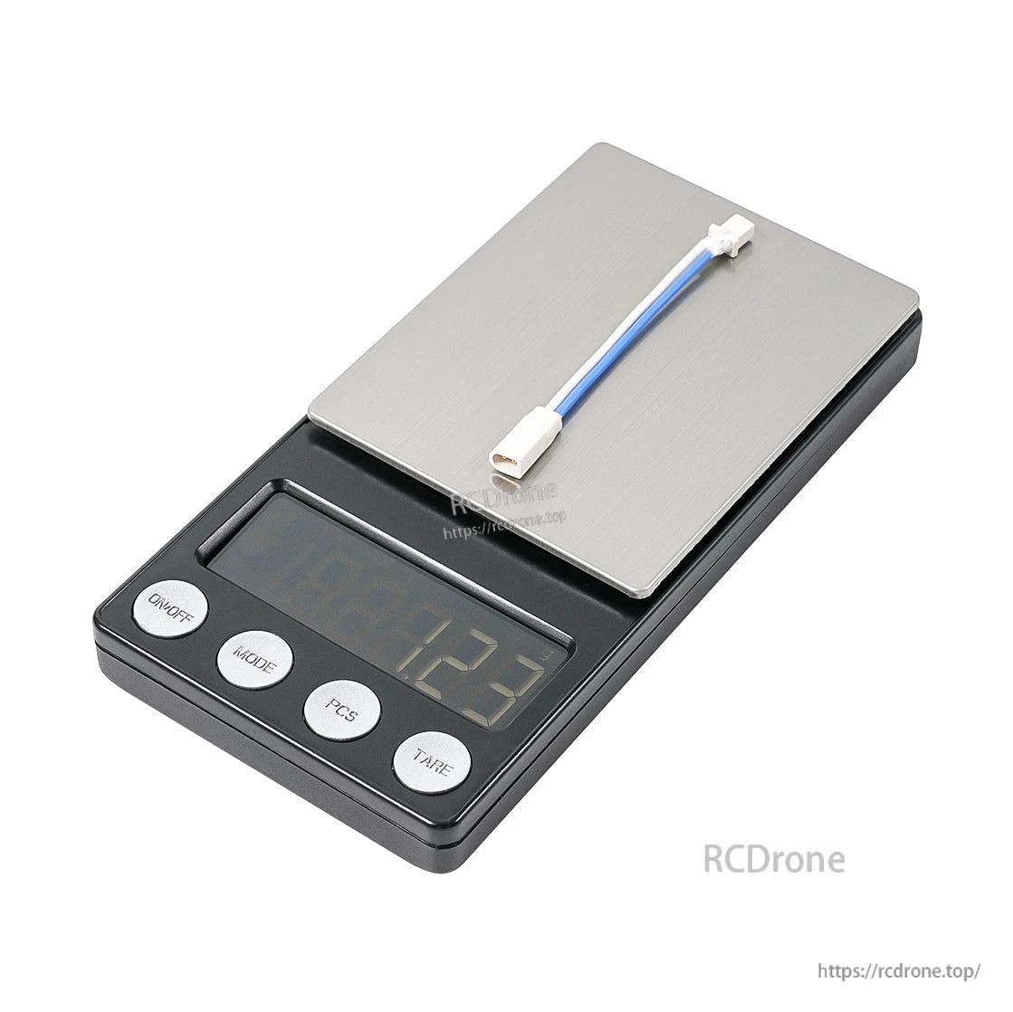 Adapter cable shown on digital scale, weight display reads 12.3 g