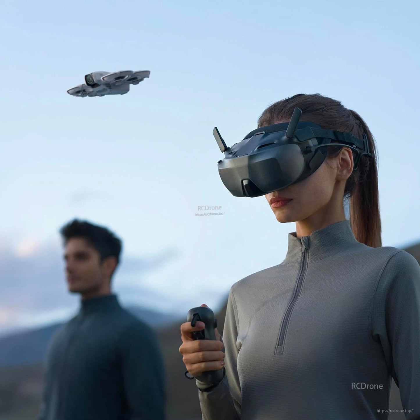 DJI Goggle, Person wearing DJI FPV goggles with antennas while holding a controller as a drone flies overhead