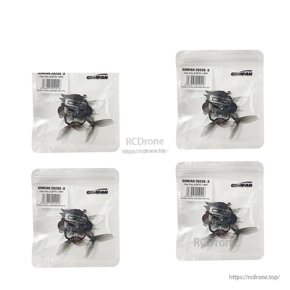 Four Gemfan 2023S-3 clear gray propeller packs arranged in a 2x2 layout