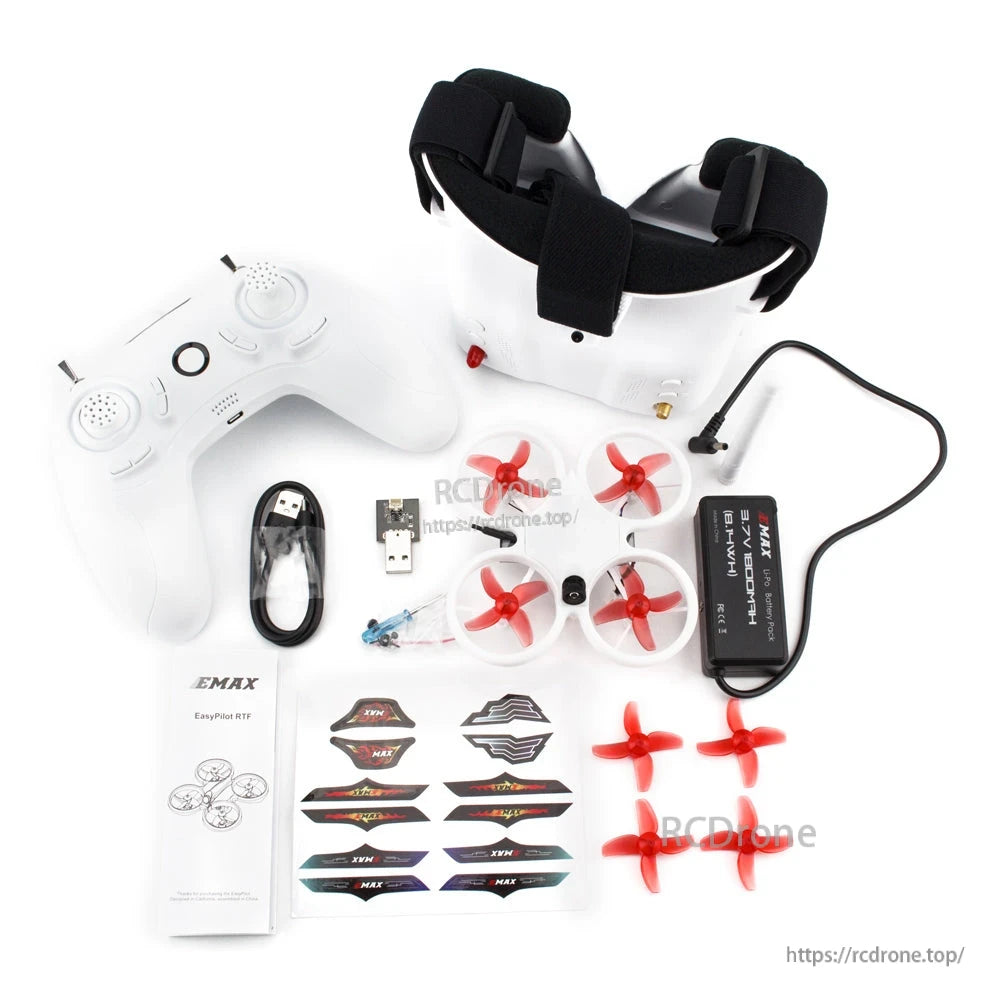 Package contents laid out: goggles, radio, USB cable, battery charger, spare props, decals, manual
