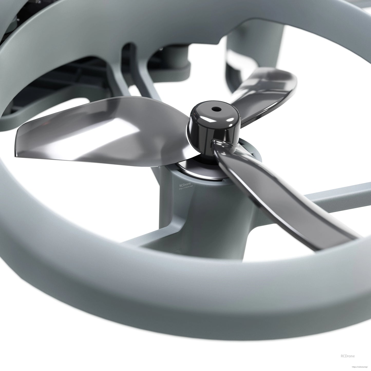 Propeller and motor close-up inside ducted guard, showing three-blade prop hub and shroud ring