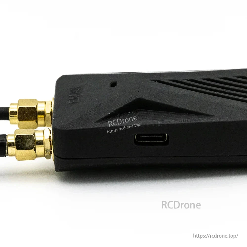 Side profile close-up showing USB-C port and dual antenna connectors on the receiver