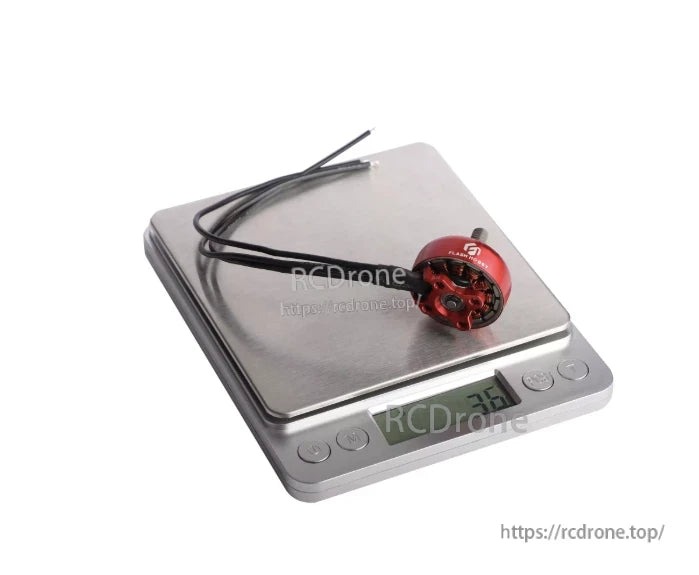 Flashhobby K2306.5 brushless DC motor in red on a digital scale, with attached motor wires