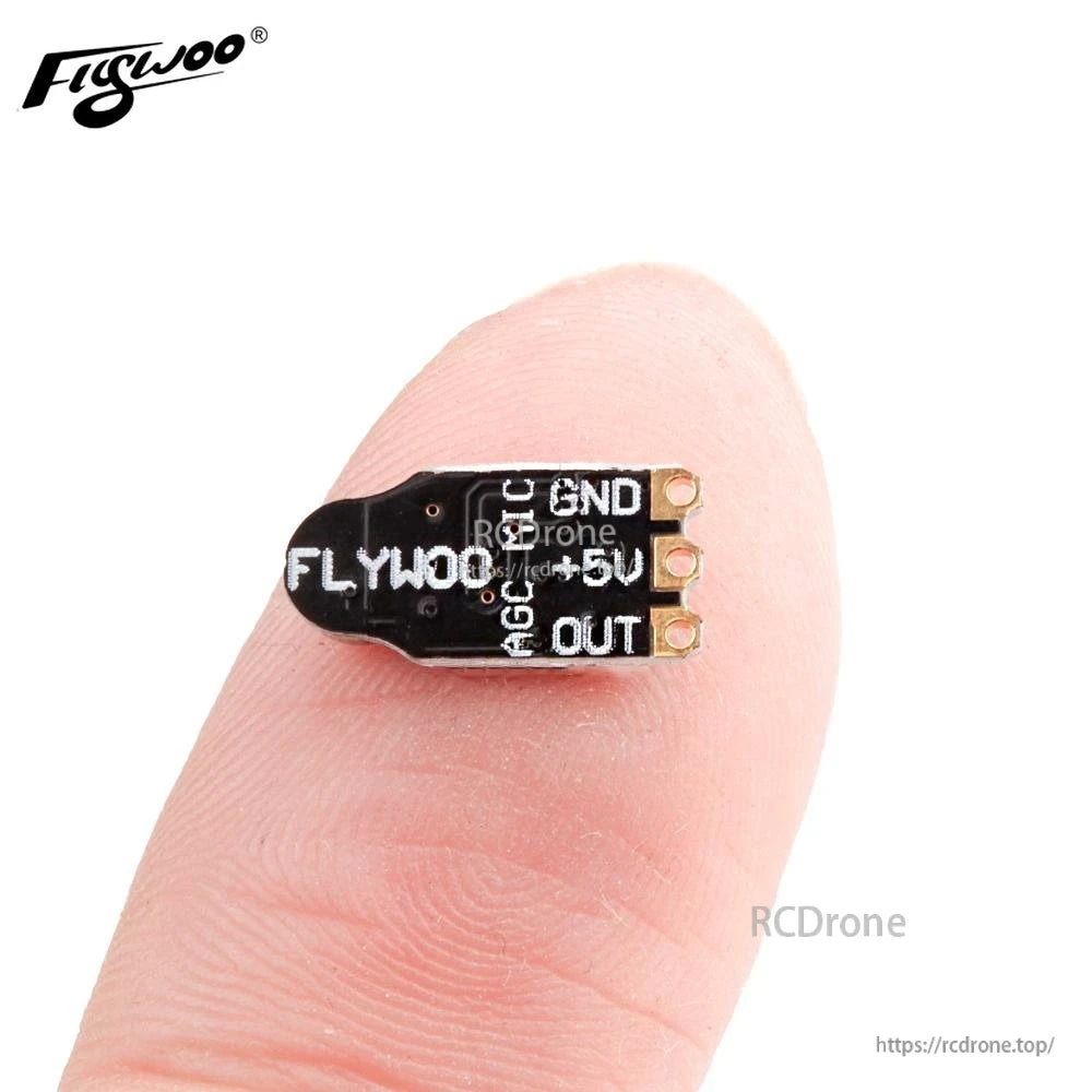 Flywoo AGC-MIC Nano VTX microphone module with labeled pads (GND, 5V, OUT) on a fingertip