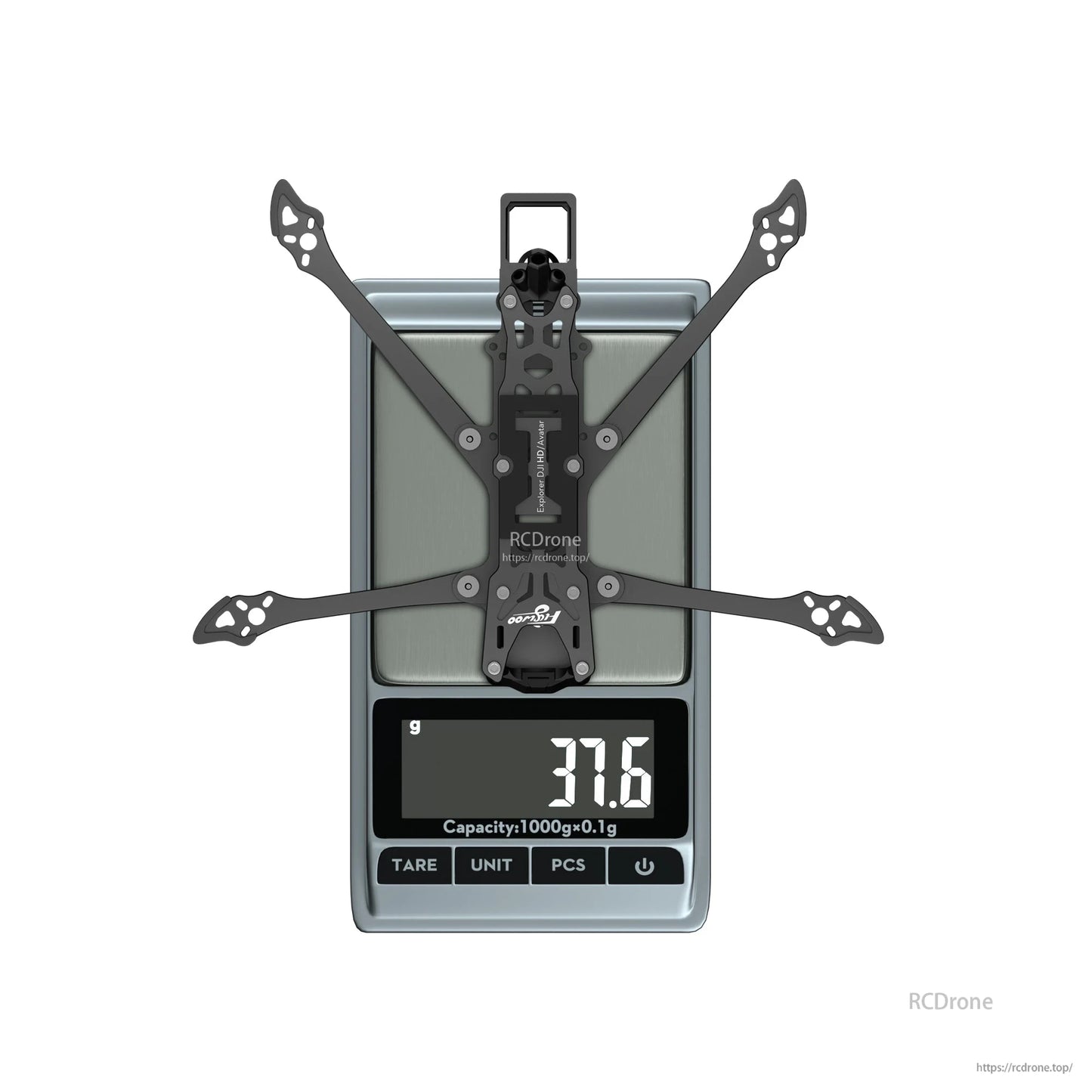 Flywoo Explorer LR4 drone frame kit on a digital scale, showing 37.6g weight with wide carbon arms