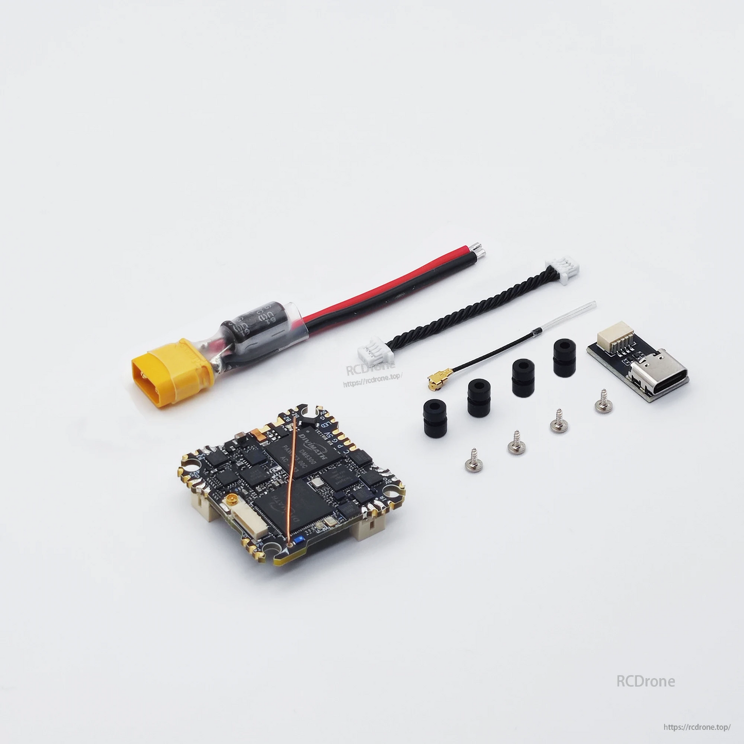 Package contents: AIO board, XT30 power lead, wiring harness, mounting grommets, screws, and small module