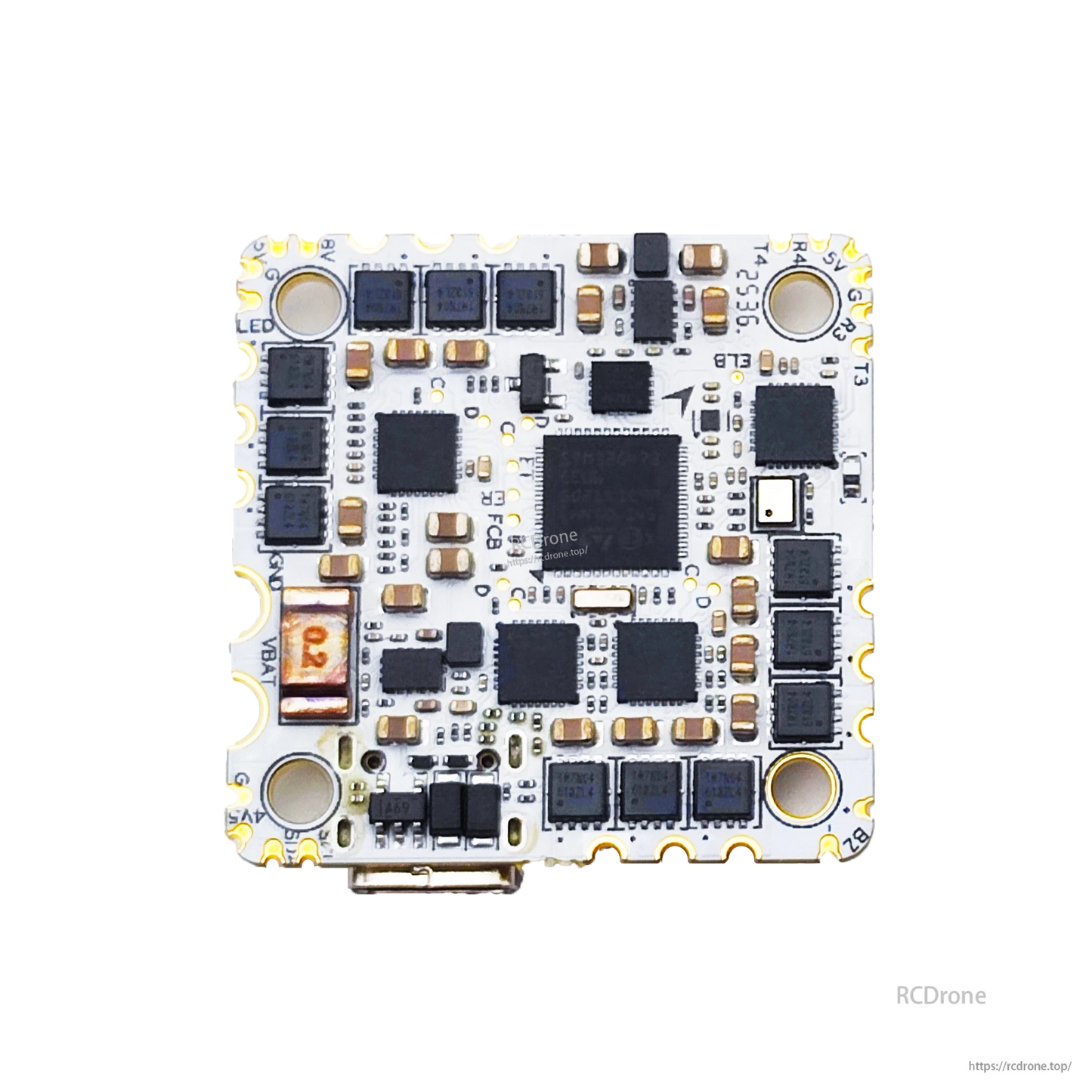 Close-up underside of AIO flight controller board showing MOSFET rows, processor, and edge pads
