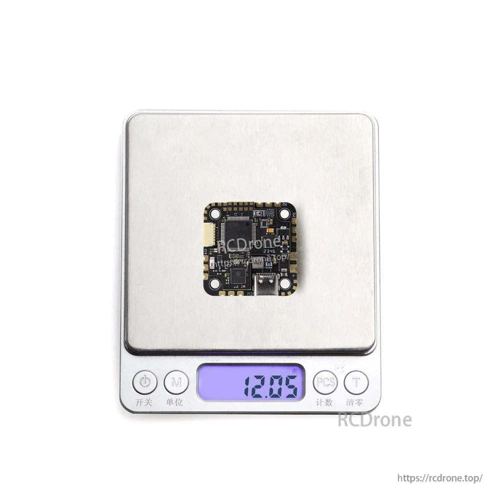 SPECTER 25A AIO board on digital scale showing 12.05 g weight display