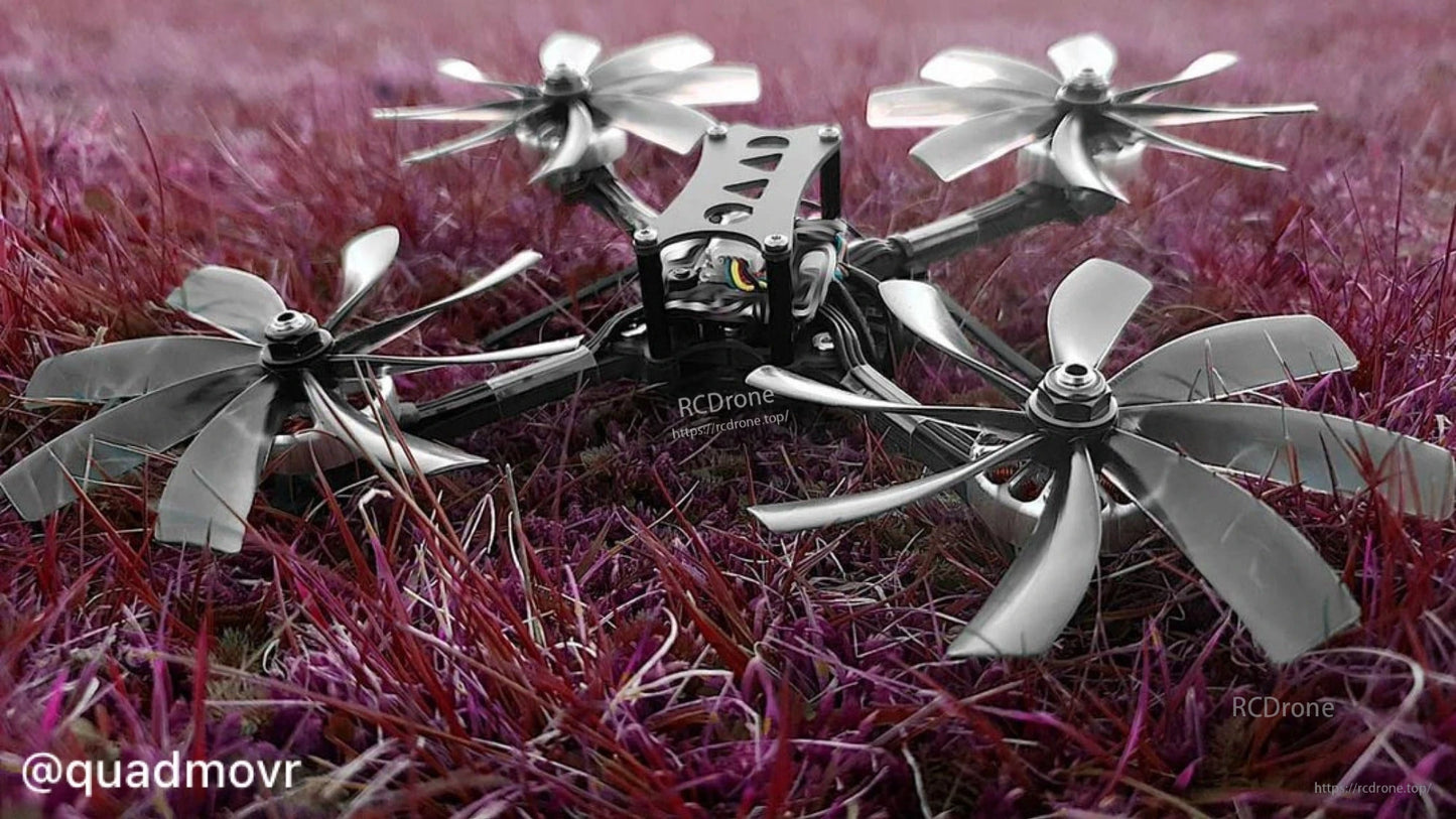 Cinewhoop drone on grass fitted with grey 8-blade ducted propellers, low-angle view