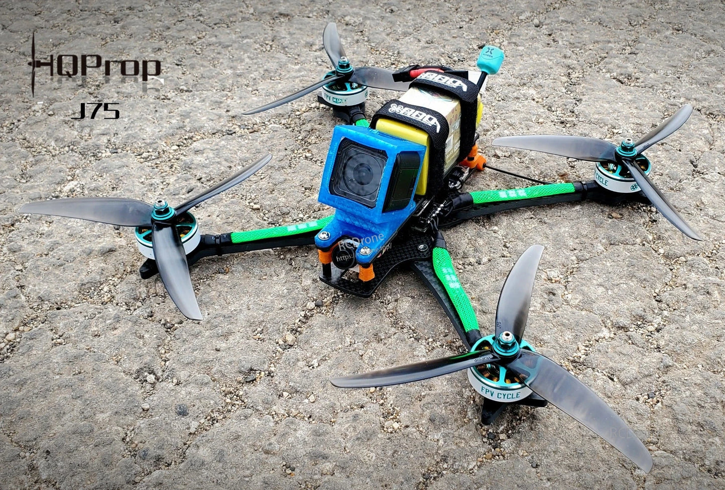 J75 tri-blade propellers installed on an FPV quadcopter drone, outdoor ground setup