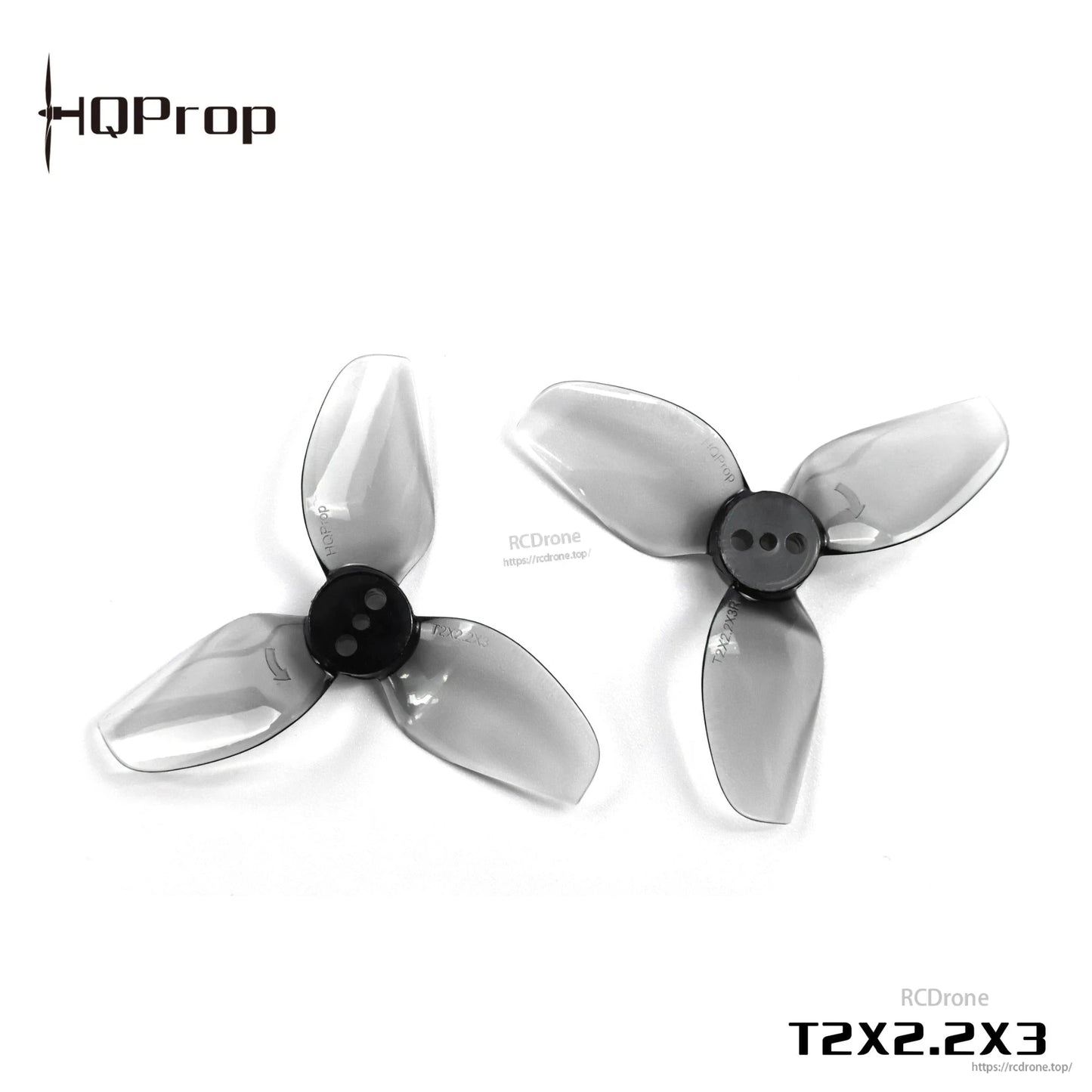 Angled view of two grey transparent 3-blade propellers with black centers, HQProp T2X2.2X3