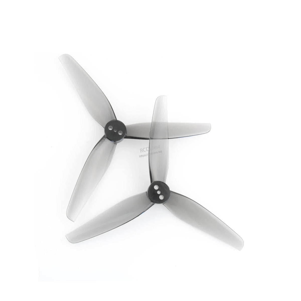 Two grey 3-blade polycarbonate FPV drone propellers with black hubs, top view on white background