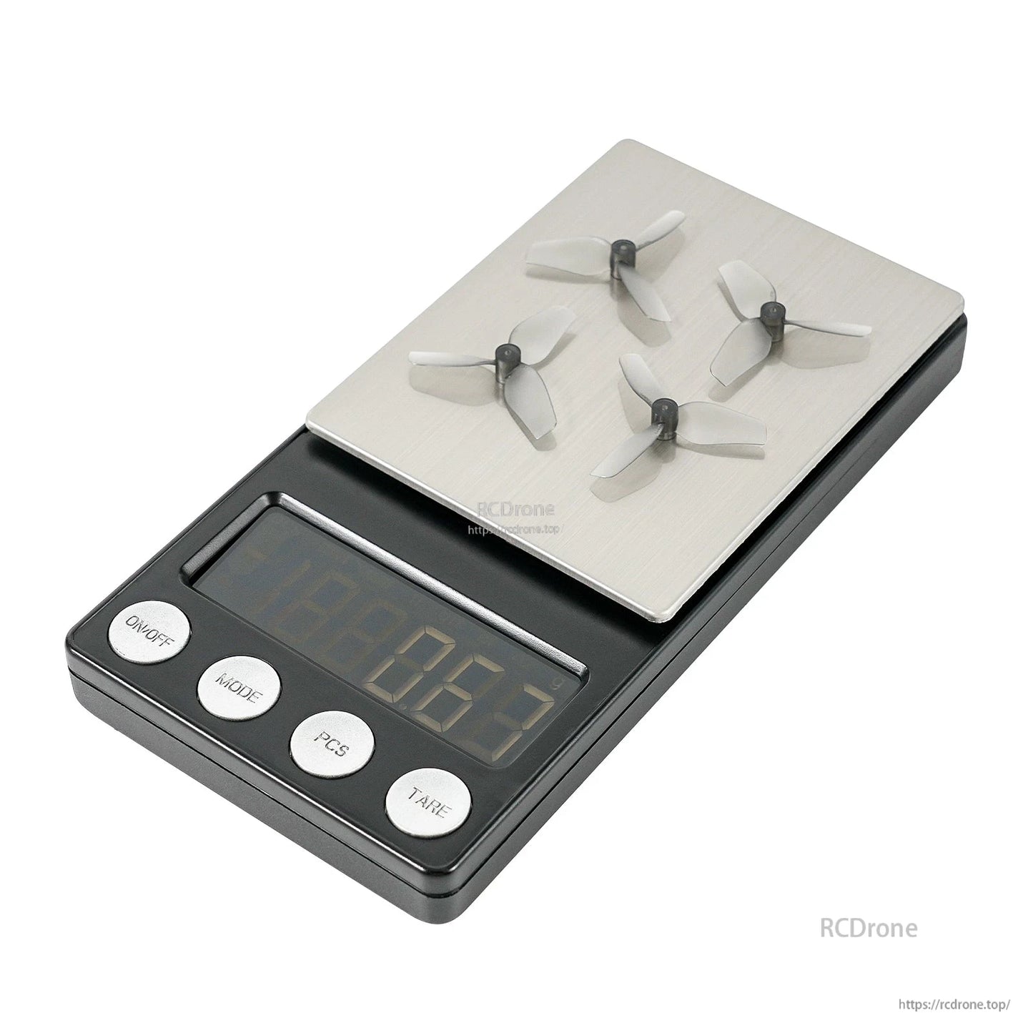 Four 3-blade micro propellers shown on a digital scale for weight reference