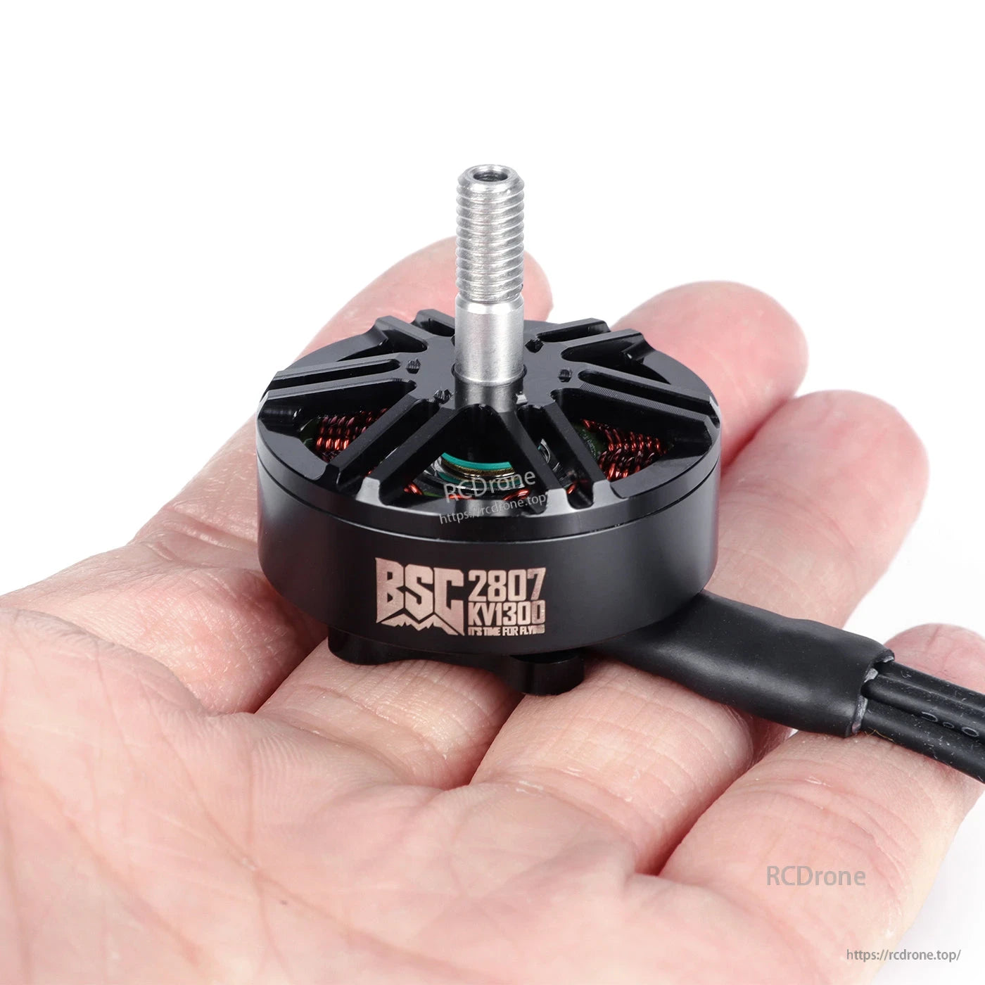 MAD BSC2807 V1.0 FPV Drone Motor, MAD BSC2807 V1.0 FPV drone brushless motor in hand with threaded shaft, vented bell, and attached wires