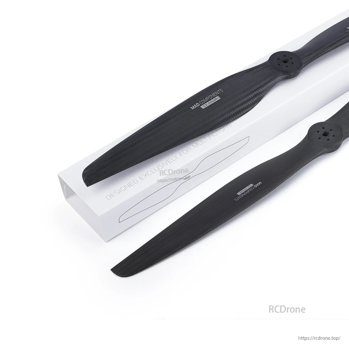 MAD FLUXER EVTOL Carbon Fiber Propeller, Carbon fiber eVTOL propeller set with two black blades and mounting hubs, displayed beside a white box