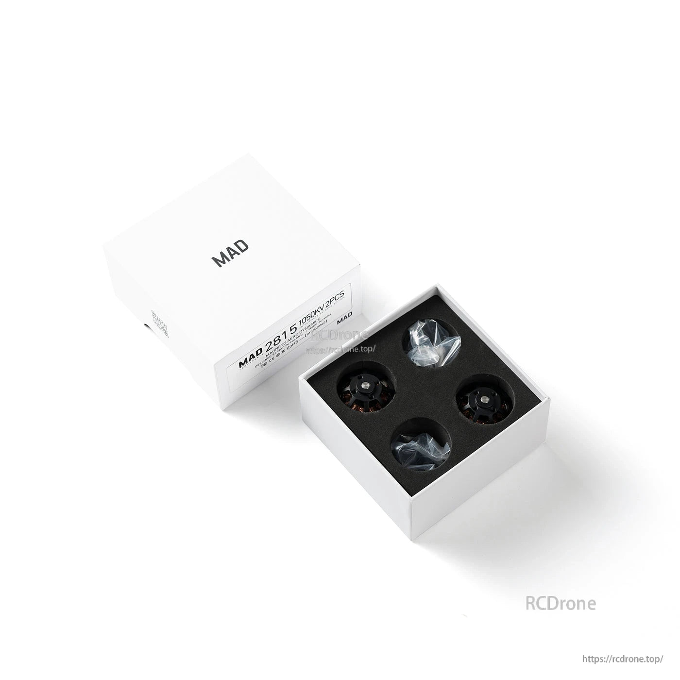 MAD X2815 brushless drone motors in foam-lined box, with two motors and accessory bags inside packaging