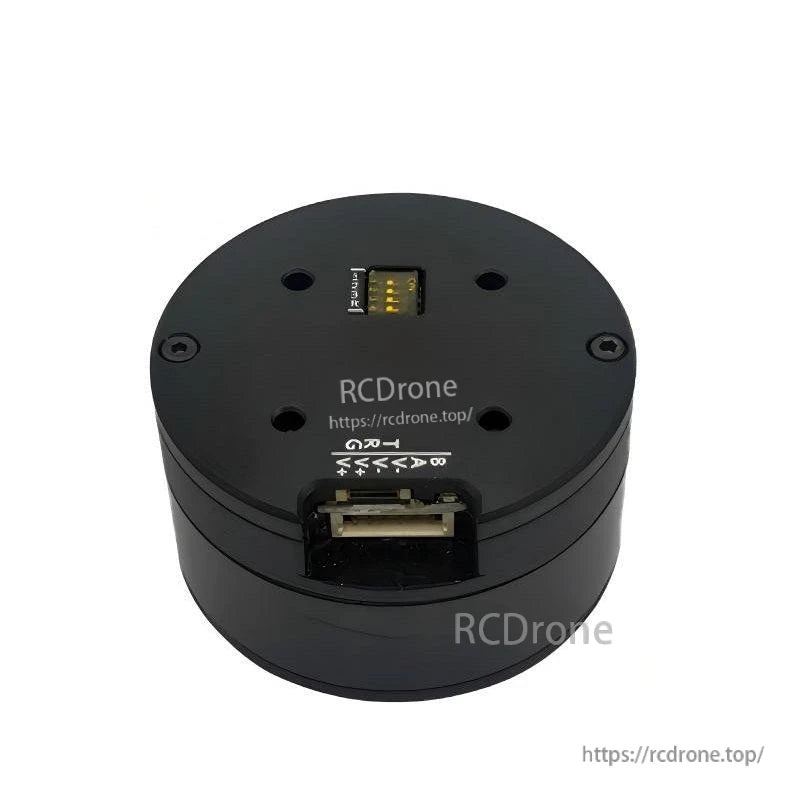 Top view of round servo motor showing wiring connector slot and pin label markings