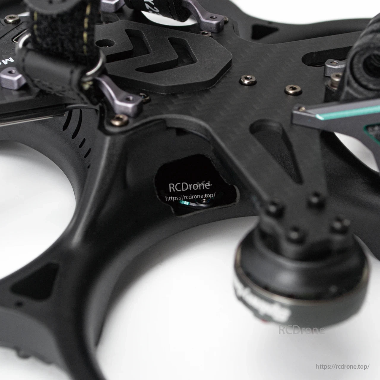 Close-up of frame side cutout and carbon fiber top plate with screws and mounting hardware