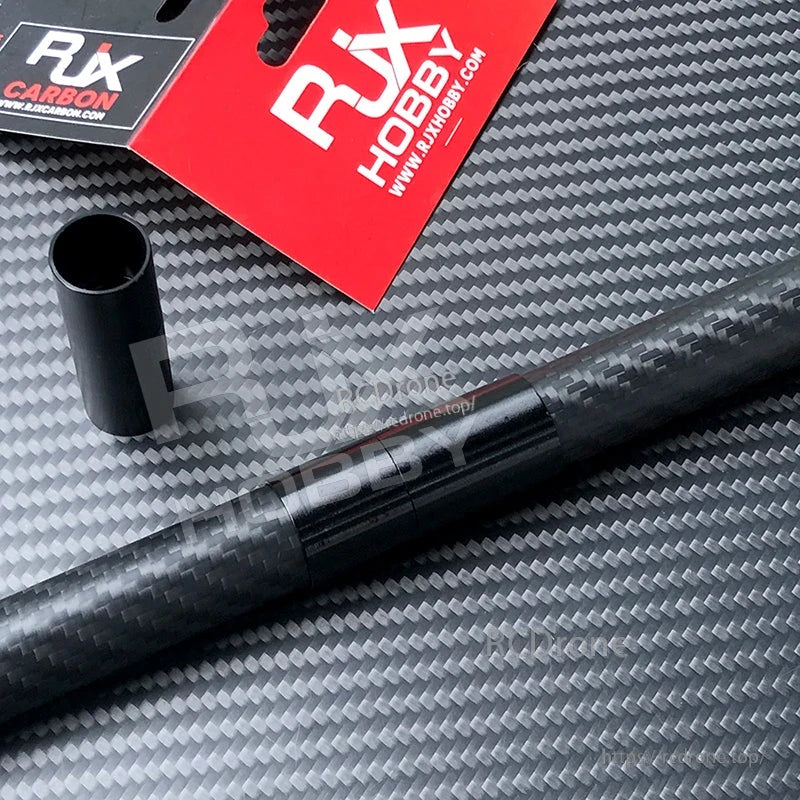 RJX 1pcs Aluminum Pipe Connector, RJX black aluminum pipe connector sleeve next to a carbon fiber tube on a carbon-pattern surface