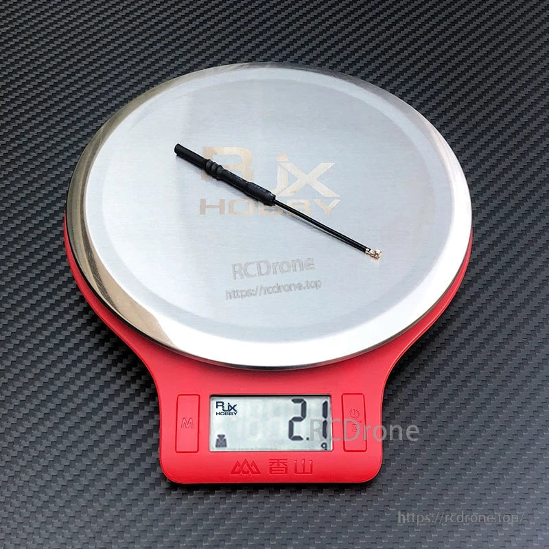 RJX 2pcs 5.8G 5dBi Omnidirectional IPEX 1 Antenna, RJX 5.8GHz IPEX1 omnidirectional antenna on a digital scale, showing a compact lightweight coax whip design.