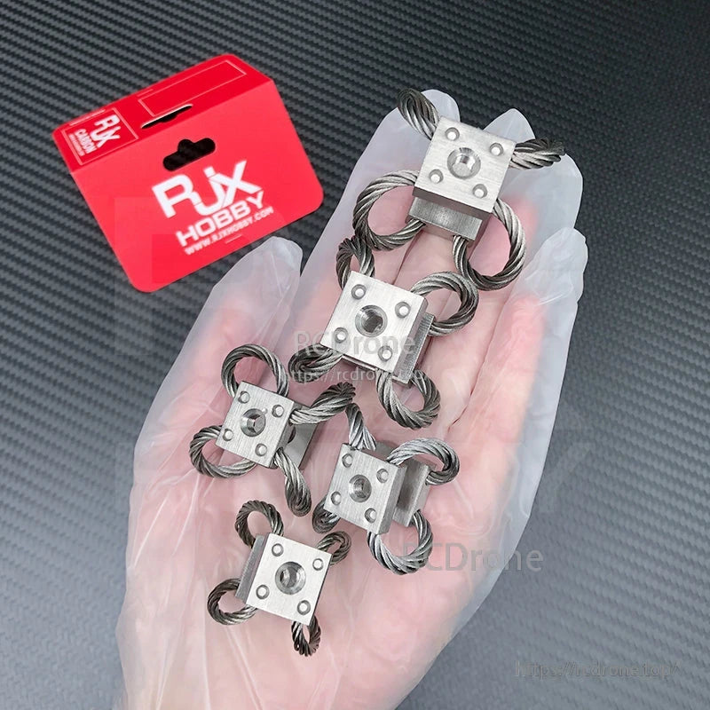 Set of four RJX steel wire rope gimbal isolator dampers with square metal mounts, shown in hand