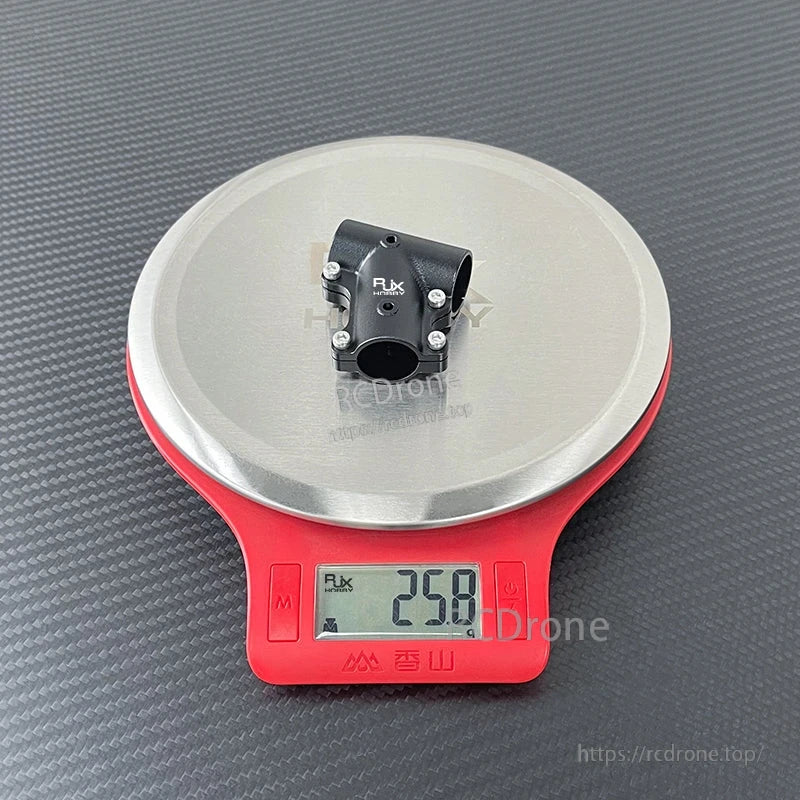RJX aluminum 18mm to 18mm tee joint landing gear connector on a digital scale reading 25.8 g