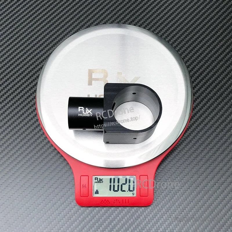 RJX aluminum landing gear tube connector on digital scale showing 102.0 g weight