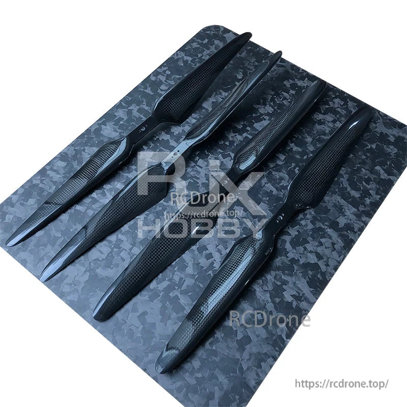 RJXHOBBY 1860 18-Inch 3K Carbon Fiber Propeller, RJXHOBBY 18-inch 3K carbon fiber propellers laid out in pairs on a textured surface