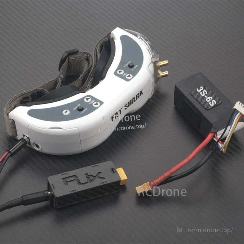 RJXHOBBY 7.4V BEC, RC BEC power adapter module labeled 3S-6S with XT60 lead and balance-style connector beside Fat Shark FPV goggles
