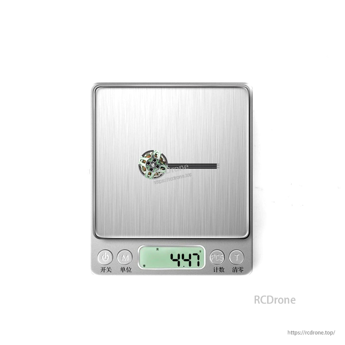 Motor shown on digital scale with display reading 4.47 g for weight reference