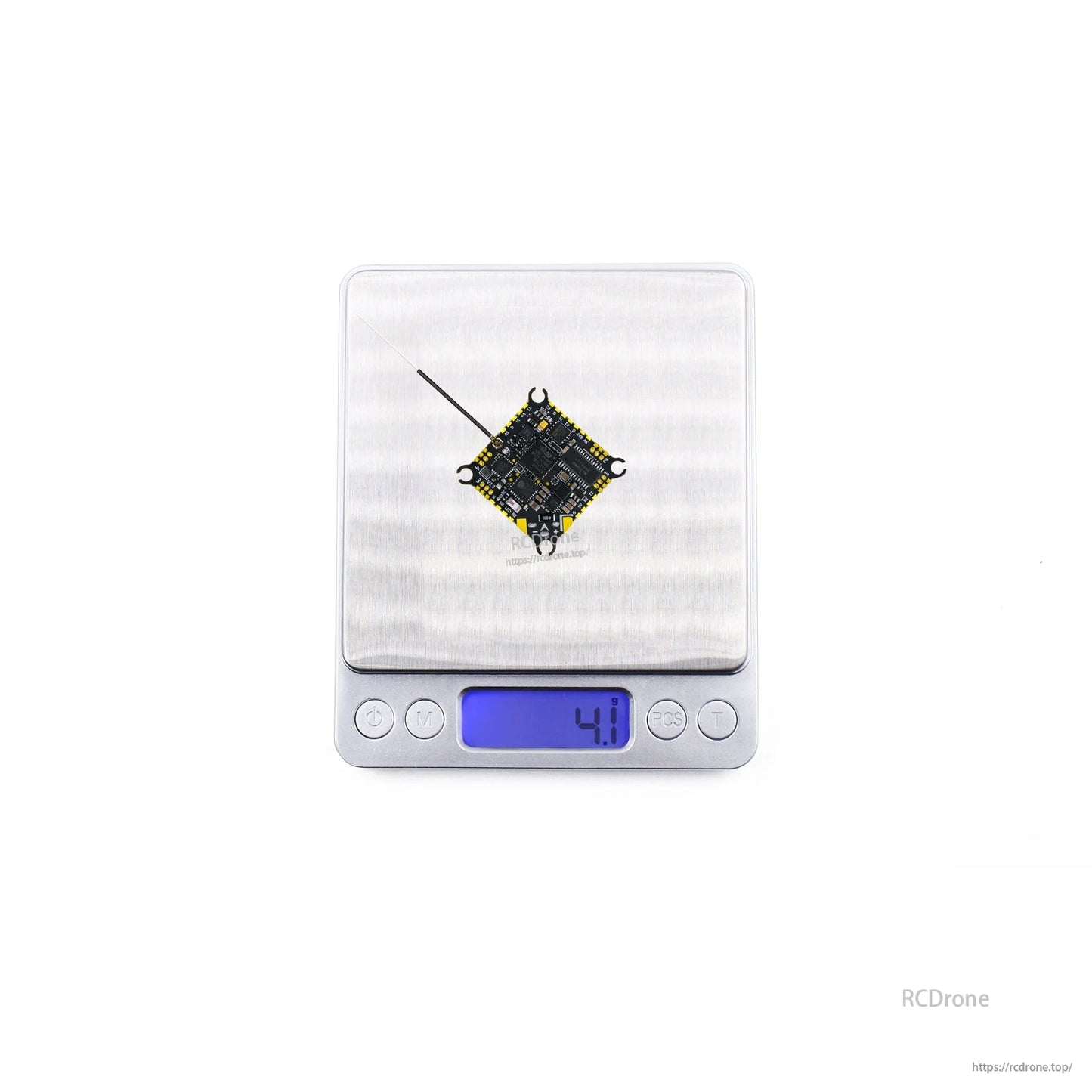 Flight controller on digital scale showing 4.1 g weight reading with antenna attached