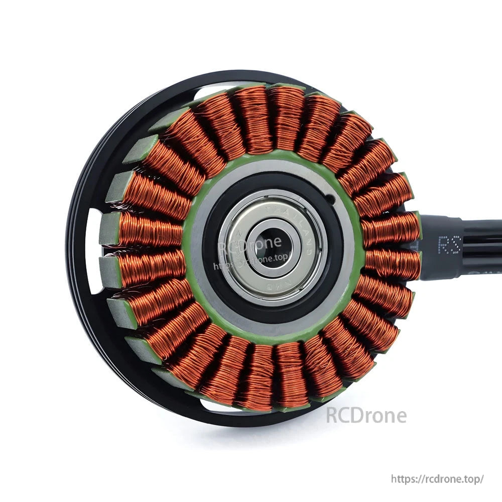 Brushless motor stator close-up showing copper windings and center bearing