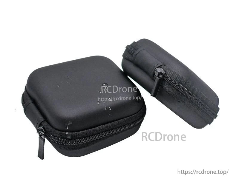 Angled view of two compact black zip cases with zipper track and pull tab visible for small electronics