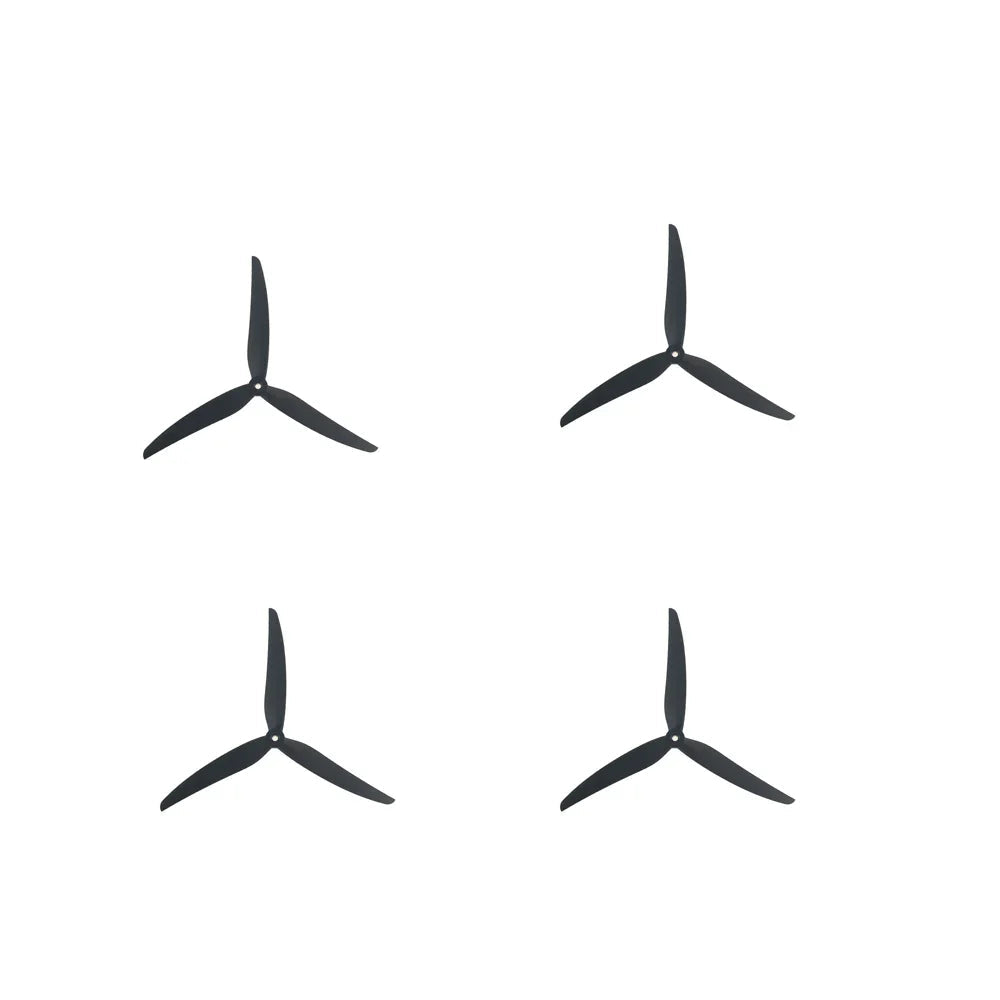 Set of four black tri-blade propellers arranged in a grid, 2 pairs for quadcopter use