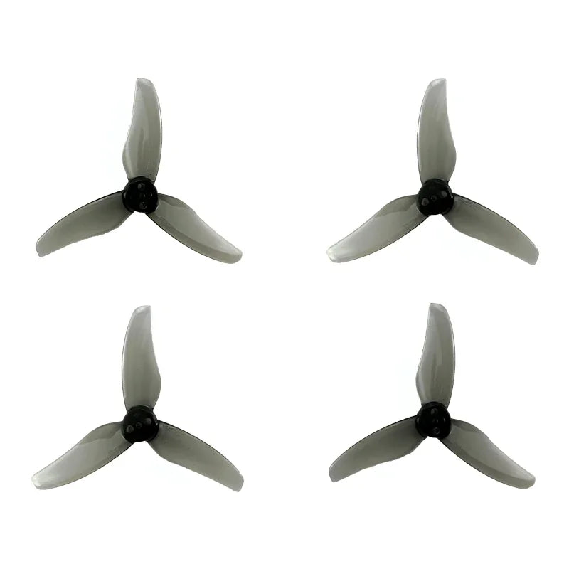 Set of four gray 3-blade FPV drone propellers with black hubs, top-down view