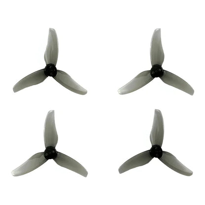 Set of four gray 3-blade FPV drone propellers with black hubs, top-down view