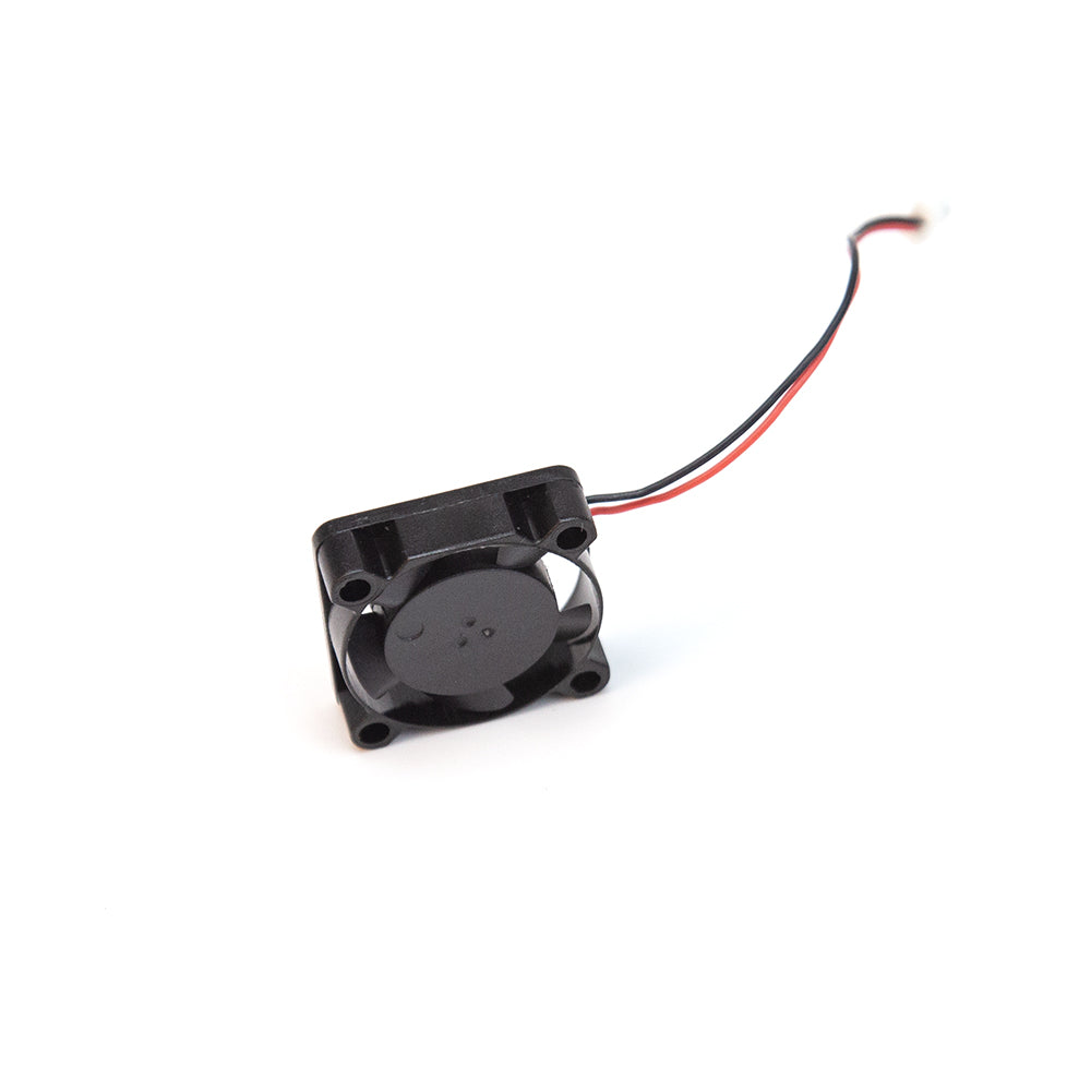 Angled view of compact square cooling fan with four corner screw holes and red/black power lead