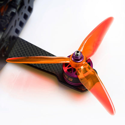 DALPROP SplitFire T5148.5 Racing Propeller, DALPROP SplitFire T5148.5 translucent orange tri-blade racing propeller mounted on a drone motor