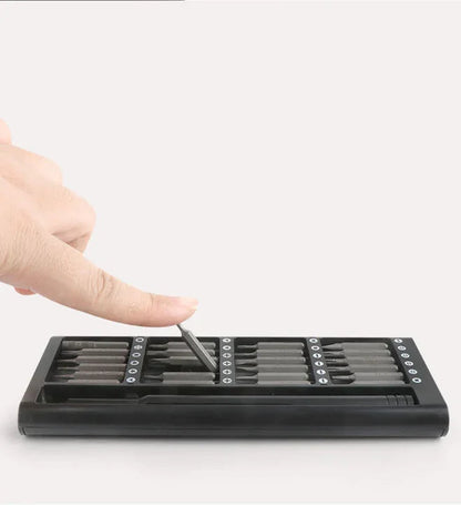 Hand pressing a precision bit in the slim storage tray, showing easy access and magnetic retention