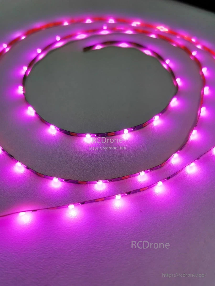 Flexible LED strip light glowing purple, coiled on surface to show brightness and LED spacing