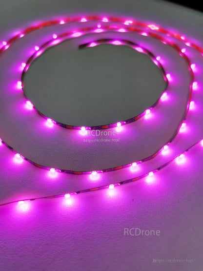 Flexible LED strip light glowing purple, coiled on surface to show brightness and LED spacing