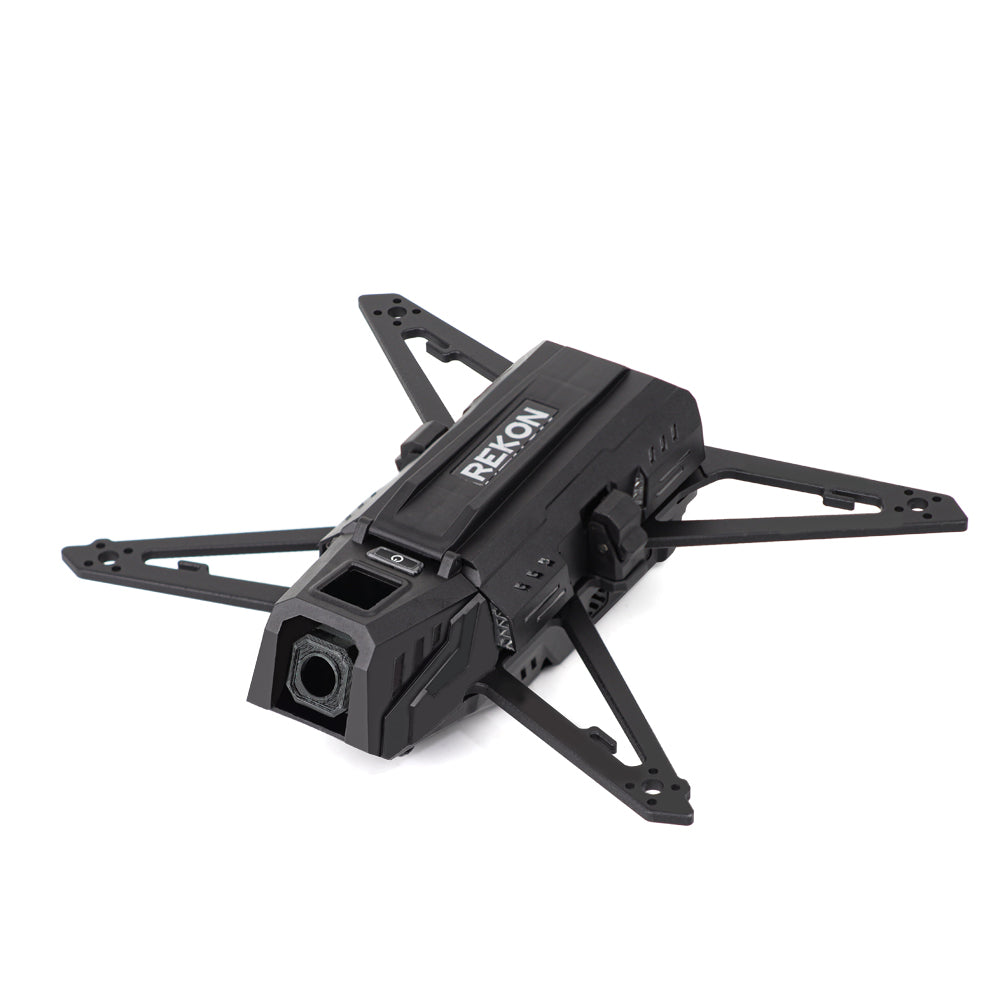 Front three-quarter view of Rekon35 V2 carbon fiber frame showing camera housing and arm mounting holes