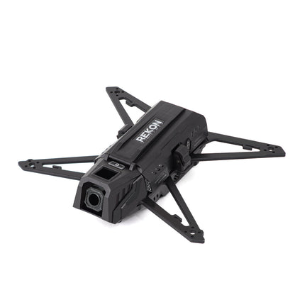 Front three-quarter view of Rekon35 V2 carbon fiber frame showing camera housing and arm mounting holes