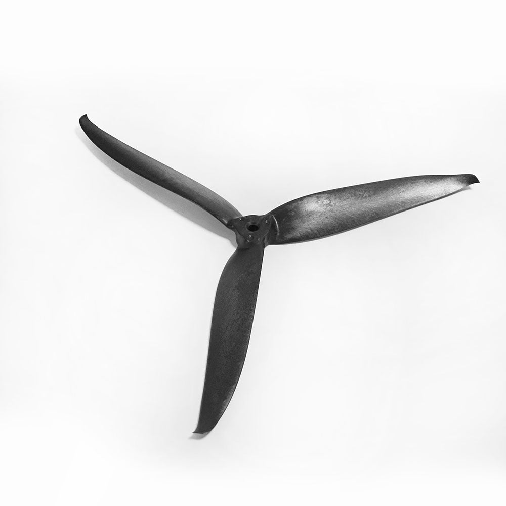 Three-blade FPV drone propeller in black, angled view showing blade shape and pitch